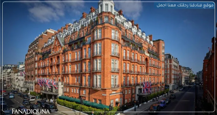 a large brick building with many windows with Harrods in the background